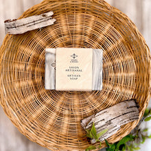 Load image into Gallery viewer, The soap bar is labeled and wrapped with recyclable paper for an eco-friendly touch. The label features the company logo and the words Artisan Soap in both French and English.