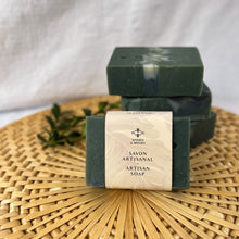 Load image into Gallery viewer, The soap bar is labeled and wrapped with recyclable paper for an eco-friendly touch. The label features the company logo and the words Artisan Soap in both French and English.