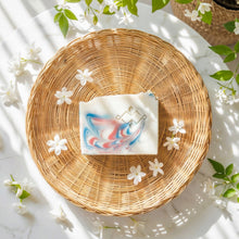 Load image into Gallery viewer, Jasmine soap bar on a woven plate with flowers and leaves