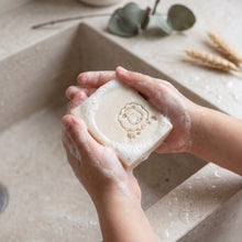 Load image into Gallery viewer, Cream lamb tallow soap bar with sheep stamp, wet and foamy in use