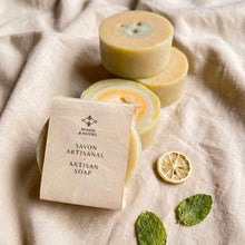 Load image into Gallery viewer, Round artisan soap wrapped in minimalist Woods and Mosses label showing lemon and mint tones