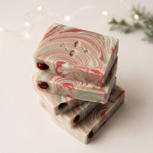 Charger l'image dans la galerie, Five stacked Christmas soap bars with red jasper stones, stamped motif, and red, cream, and pale green marbling.