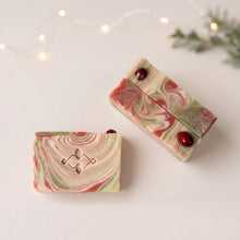 Charger l'image dans la galerie, Three marbled Christmas soap bars showing red jasper stones, silver mica shimmer, and red, cream, and pale green swirls.