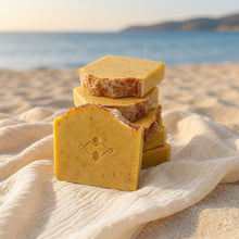 Load image into Gallery viewer, Mango handmade soap bar with Woods and Mosses logo stamp in front of five stacked artisan bars.
