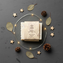 Load image into Gallery viewer, artisan shea butter marble soap wrapped in a Woods and Mosses label with decorative wooden stars and pinecones