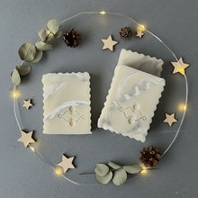 Load image into Gallery viewer, three artisan shea butter marble soap bars arranged diagonally on a grey surface with wooden stars and pinecones