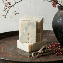Load image into Gallery viewer, Stacked Marble soap bars on a rustic metal surface with decorative elements.