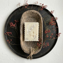 Load image into Gallery viewer, Bar of soap with marble design on a stone dish surrounded by red berries on a white background