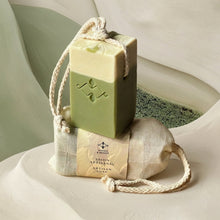 Load image into Gallery viewer, Matcha latte soap on a rope bar stacked on its wrapped wash bar, showing cream and green layers.
