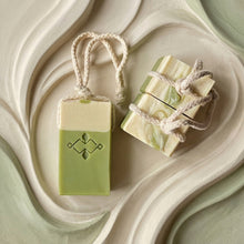 Load image into Gallery viewer, Three matcha latte soap on a rope bars, one front facing and one showing the marbled top and braided cord.
