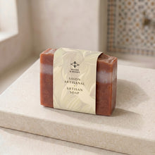 Load image into Gallery viewer, Moroccan clay artisan soap bar with cream paper sleeve, terracotta edges, and white stripe