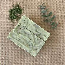 Load image into Gallery viewer, Nettle &amp; Eucalyptus artisan soap bar top view, showing herbal speckles and wavy top