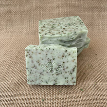 Load image into Gallery viewer, Nettle &amp; Eucalyptus artisan soap bars showing the Woods and Mosses stamped front bar and herbal speckled texture