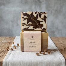 Load image into Gallery viewer, Wrapped Moroccan Rhassoul clay artisan soap bar with branded sleeve and a matching oak leaf design bar behind.