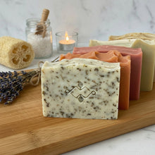 Load image into Gallery viewer, close view of pale green handmade soap bar with herbs and texture in a natural gift set