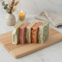 Load image into Gallery viewer, side view of five handmade vegan soap bars showing different colors and textures, natural skincare gift set
