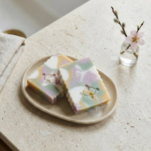 Load image into Gallery viewer, Two pastel soap bars on a dish, with soft marbled swirl pattern in pink, mint, yellow and white.