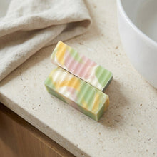 Load image into Gallery viewer, Two rectangular pastel soap bars showing side swirl pattern in pink, green, yellow and cream.
