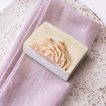 Load image into Gallery viewer, Handmade peony soap bar with raised pastel flower detail and creamy rectangular shape
