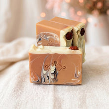 Load image into Gallery viewer, Unwrapped pumpkin soap bars showing orange swirl faces, cream whipped tops, stamped logo, and small pumpkin embeds