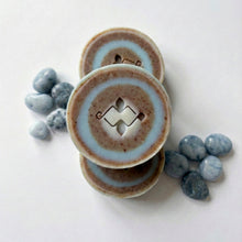 Load image into Gallery viewer, Three round artisan soap bars with blue and brown rings stacked together, showing a clean carved center design.