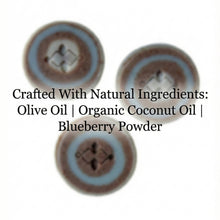 Load image into Gallery viewer, Three round artisan soap bars with blue and brown swirl layers arranged in a triangular layout