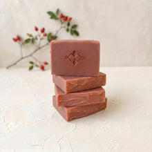 Load image into Gallery viewer, Four rosehip artisan soap bars stacked vertically, with one embossed bar on top and layered hand-cut sides visible below.