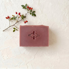 Load image into Gallery viewer, Top view of a single rosehip artisan soap bar with a smooth rectangular shape and centered embossed logo.