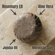 Load image into Gallery viewer, Close-up of a natural shampoo bar with labeled ingredients on a beige background