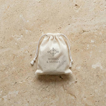 Load image into Gallery viewer, Cotton drawstring bag for a rosemary mint men's shampoo bar with Woods and Mosses logo.