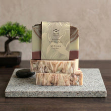 Load image into Gallery viewer, Wrapped sandalwood natural soap bar displayed with two matching artisan bars