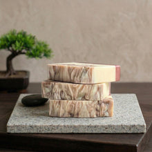 Load image into Gallery viewer, Side view of three stacked handmade sandalwood natural soap bars with marbled brown swirl pattern