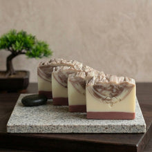 Load image into Gallery viewer, Four handmade sandalwood natural soap bars in a row with ivory base and brown swirl tops