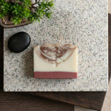 Load image into Gallery viewer, Top view of a single handmade sandalwood natural soap bar with ivory base and brown swirl top