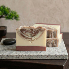 Load image into Gallery viewer, Front-facing sandalwood natural soap bar with two matching stacked artisan bars behind it