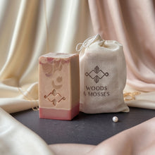 Charger l'image dans la galerie, Pink and cream silk soap bar with decorative stamp beside Woods and Mosses muslin gift bag