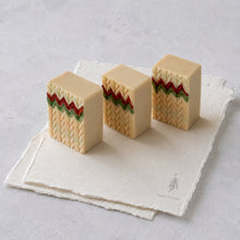 Charger l'image dans la galerie, Three handmade Christmas sweater soap bars showing cream chevron texture and red-green stripes