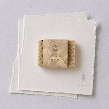 Charger l'image dans la galerie, Gift-ready Christmas sweater soap bar wrapped in a beige paper sleeve on textured white paper