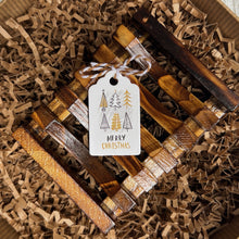 Load image into Gallery viewer, Wooden soap tray placed in kraft paper shred, decorated with a holiday gift tag that reads Merry Christmas and features small Christmas trees in green, brown, and gold tones.