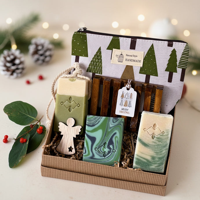 Vegan bath and body gift set with three handcrafted soaps, wooden soap dish, seasonal tree-print pouch and a wooden angel. Packed in crinkle paper and kraft box. Handmade by Woods and Mosses.
