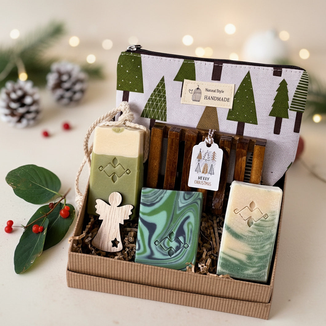 Vegan bath and body gift set with three handcrafted soaps, wooden soap dish, seasonal tree-print pouch and a wooden angel. Packed in crinkle paper and kraft box. Handmade by Woods and Mosses.