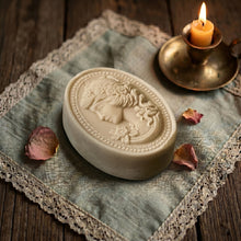 Load image into Gallery viewer, Ivory cameo soap lying flat with oval portrait relief and floral details, handmade vintage bar