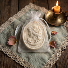 Load image into Gallery viewer, Ivory oval cameo soap in white organza bag with raised woman portrait relief