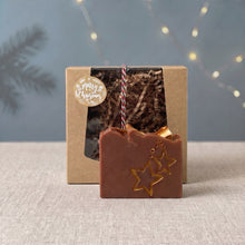 Load image into Gallery viewer, Brown Christmas Eve soap bar with hand-painted gold stars displayed in front of its kraft holiday gift box.