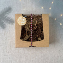 Load image into Gallery viewer, Closed kraft Christmas soap gift box with a clear window, brown paper filler, festive tricolor twine, and Merry Christmas sticker.