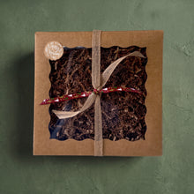 Load image into Gallery viewer, Kraft Christmas gift box with clear window, crinkle paper filler and beige ribbon, tied with red festive string.